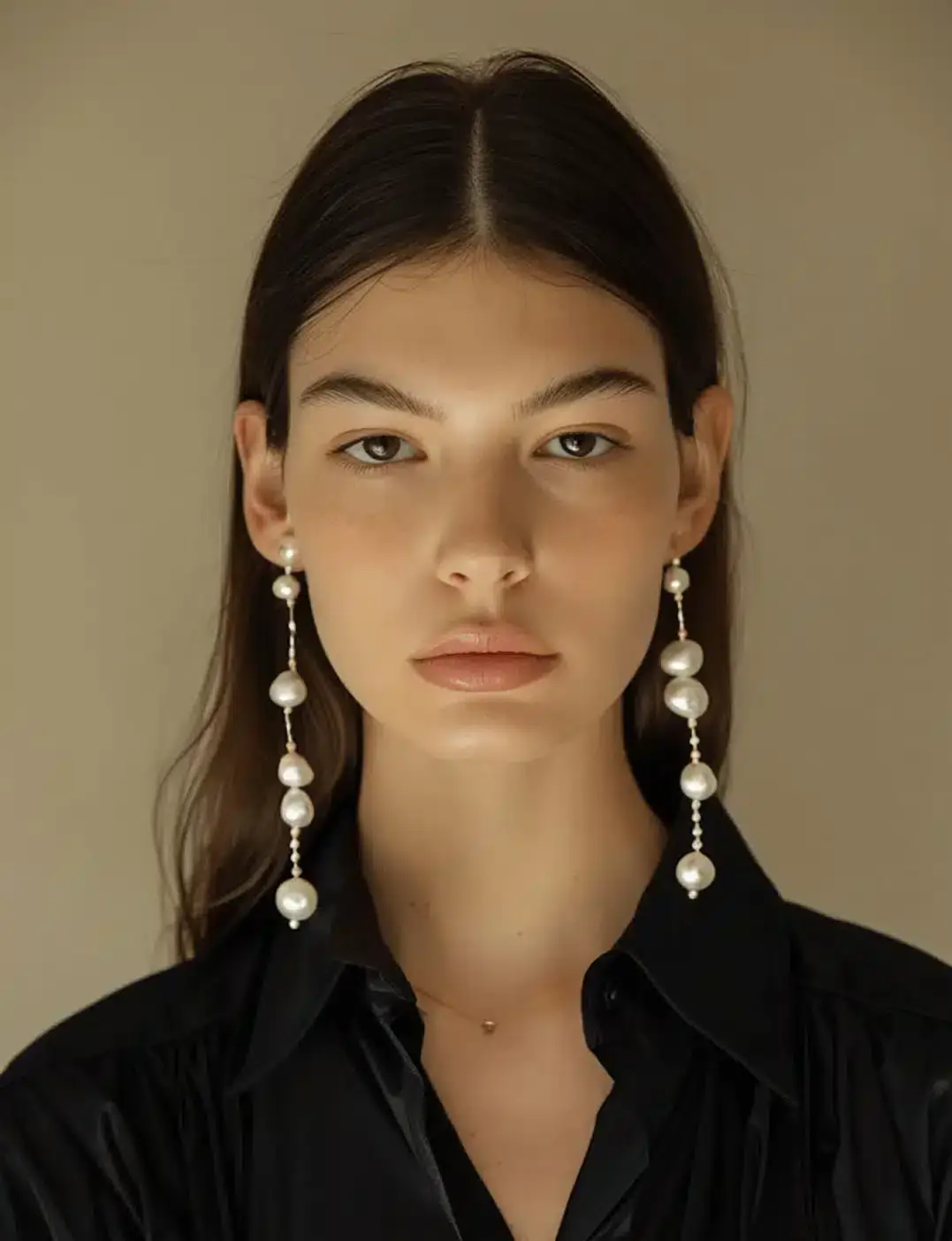 portrait of a woman with big earrings and a black shirt
