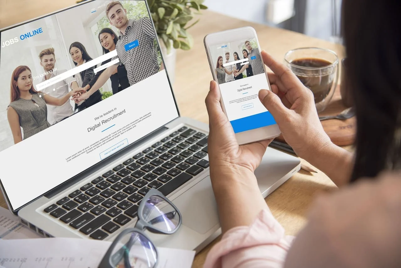 Image of a laptop and mobile device with the same webpage.